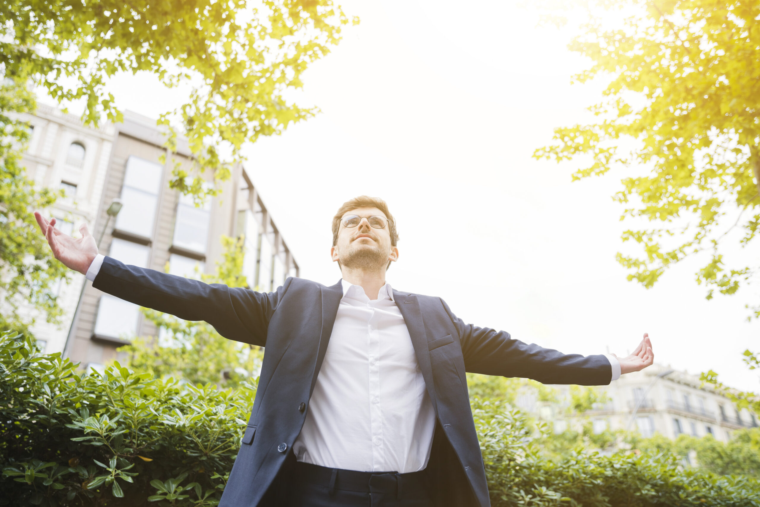 low-angle-view-businessman-standing-front-building-outstretching-his-arms Emotional Regulation Mastery